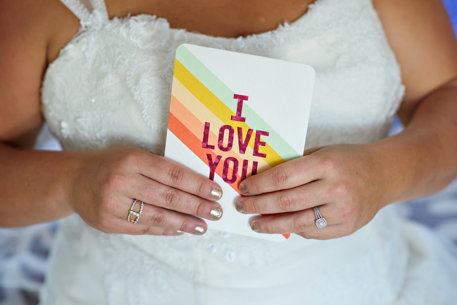 A bride holds a card from her bride to be before the ceremony.